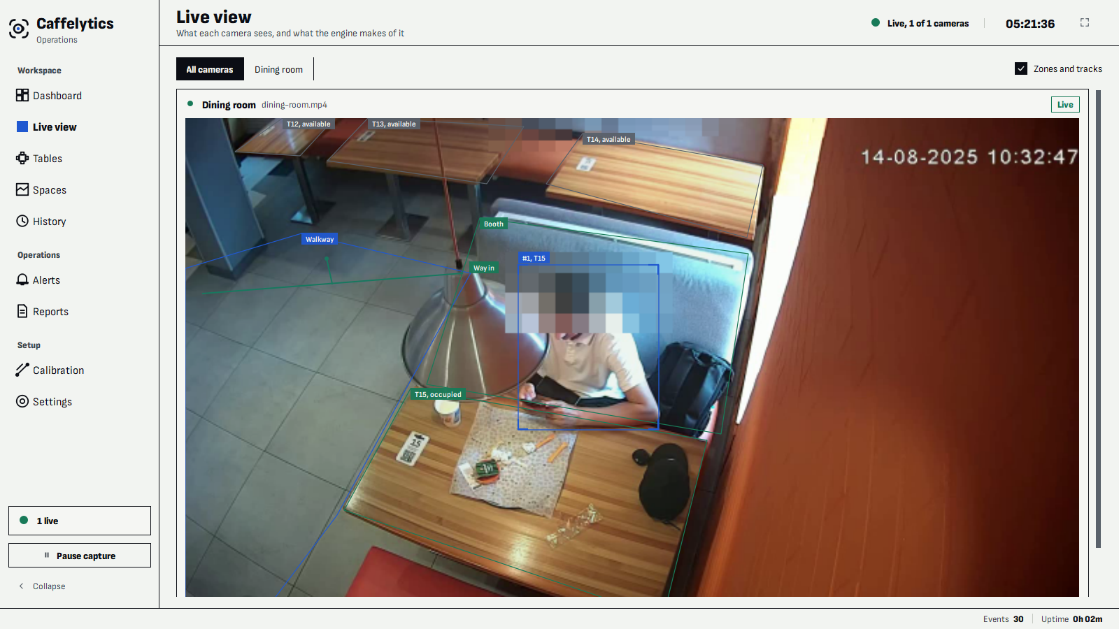 Live view: a dining room camera with the way-in line, a walkway zone, a booth area and four tables drawn over the picture. The seated customer is boxed with an anonymous number, the table beside them reads occupied, and their face is pixelated.